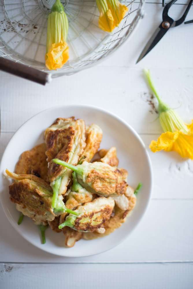 piatto con fiori di zucca ripieni di patate al forno