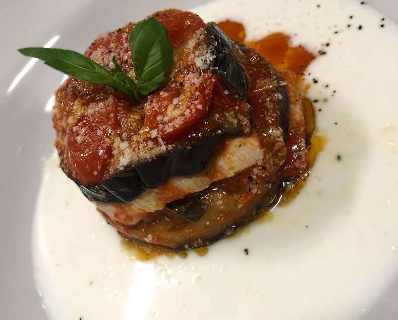 parmigiana di melanzana e branzino con colatura di provola affumicata